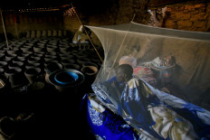 Peter Majak, a pottery maker from South Sudan, rests under a mosquito net inside a traditional pottery factory close to the banks of the Nile river, in Alqamayir, Omdurman, Sudan, February 17, 2020. Reuters/Zohra Bensemra