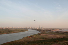 A bird flies over the convergence between the White Nile river and Blue Nile river in Khartoum, Sudan, February 17, 2020. Reuters/Zohra Bensemra     
 
