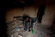 David Plantino, 35, a pottery maker from South Sudan, puts on shoes at his shelter where he sleeps during the week, as he gets ready to go to work in Omdurman, Sudan, February 18, 2020. Reuters/ Zohra Bensemra