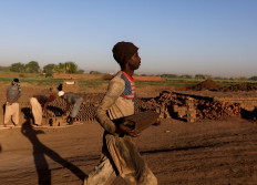 A brick maker from Ad-Damazin carries a mould of mud bricks to be dried at an open-air factory on Tuti Island, Khartoum, Sudan, February 14, 2020. Reuters/Zohra Bensemra     
