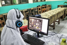 A teacher speaks to her students through a video conference platform on the first day of school at SMA 8 state senior high school in Jakarta on July 13. JP/Seto Wardhana