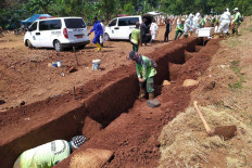 Gravediggers at Pondok Ranggon Cemetery in East Jakarta prepare burial sites for deceased COVID-19 patients on July 27. JP/P.J.Leo
