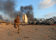 A Lebanese army soldier runs at the scene of an explosion at the port of Lebanon's capital Beirut on August 4, 2020. AFP/Str