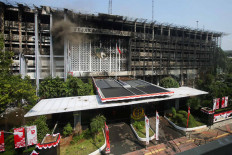 The remains of the main building in the Attorney General’s Office compound in South Jakarta continues to smolder on Aug. 25 after it was gutted by a fire the night before. The Jakarta Police have questioned 105 witnesses to determine the cause of the fire. JP/Wendra Ajistyatama