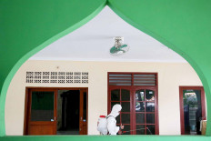 Donning personal protective equipment (PPE), a member of the National Police’s Mobile Brigade (Brimob) sprays disinfectant liquid in Al-Fatah mushala (house of prayer) in the National Police’s Munjul Baru housing complex in East Jakarta on Oct. 12. The measure was taken to maintain the area’s cleanliness amid the COVID-19 pandemic. JP/P.J.Leo