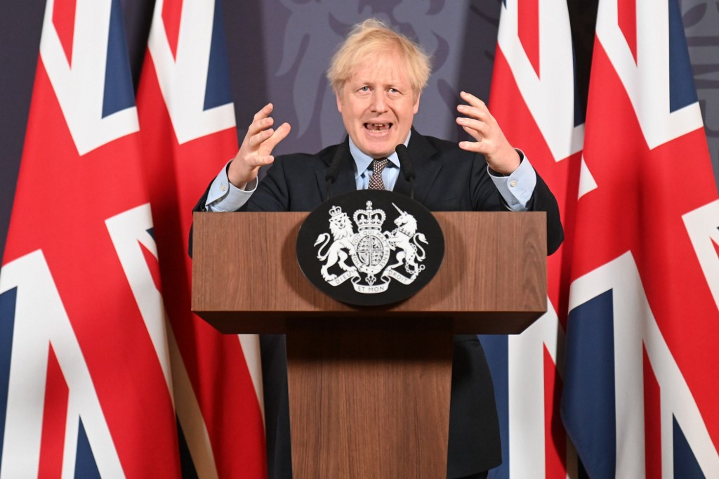 Britain's Prime Minister Boris Johnson gestures as he holds a remote press conference to update the nation on the post-Brexit trade agreement, inside 10 Downing Street in central London on December 24, 2020. Britain said on Thursday, December 24, 2020 an agreement had been secured on the country's future relationship with the European Union, after last-gasp talks just days before a cliff-edge deadline.