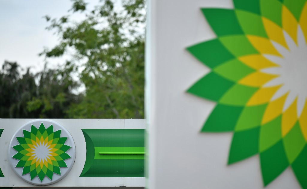 BP logos are seen at a BP petrol and diesel filling station in Hildenborough, southeast of London on June 15, 2020, following the announcement that the oil giant will take a hit of up to $17.5 billion (11.4 billion euros and 15.3 billion euros), due to the ongoing COVID-19 global pandemic. British energy giant BP said Monday that it will take a hit of up to $17.5 billion in the second quarter as 
