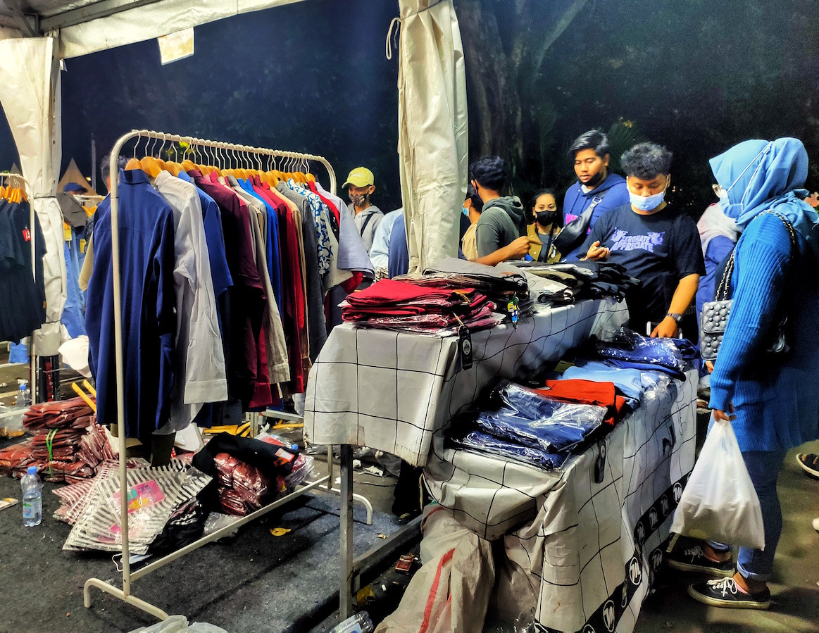 People look at second-hand and new clothes sold at the JakCloth festival in Jakarta on May 1, 2021.