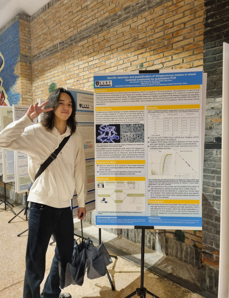 Joey Patrick Bachtiar with his SURF project poster.